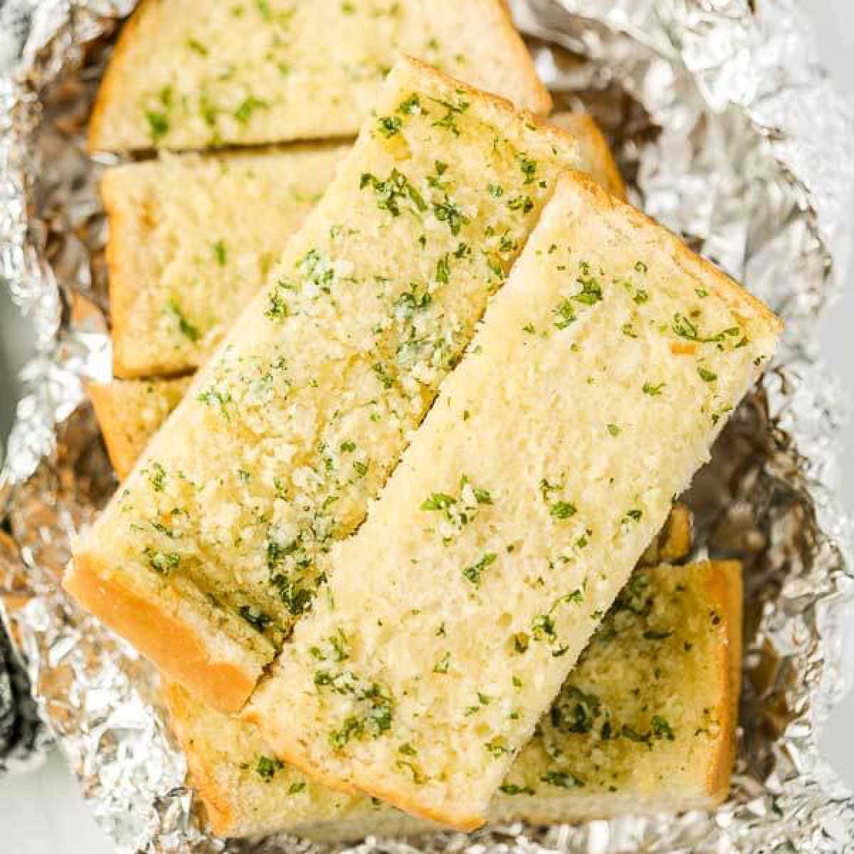 Garlic Bread on top of a piece of foil.