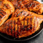 Grilled BBQ Chicken Breast on a black plate