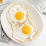 Fried eggs on a plate.