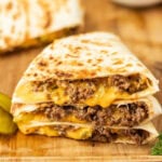 Ground Beef and melted cheese quesadilla cut and stacked on a wooden board