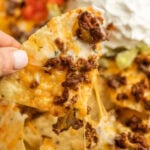 Taco nachos with beef, cheese, and sour cream.