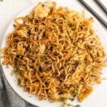 Chinese noodles with egg and chopsticks.
