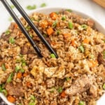 Chinese fried rice in a bowl with chopsticks.