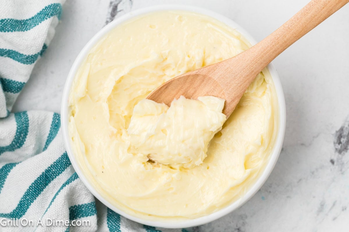 Smoked butter in a bowl with a serving on a wooden spoon
