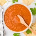 Ranchero Sauce in a bowl with a wooden spoon