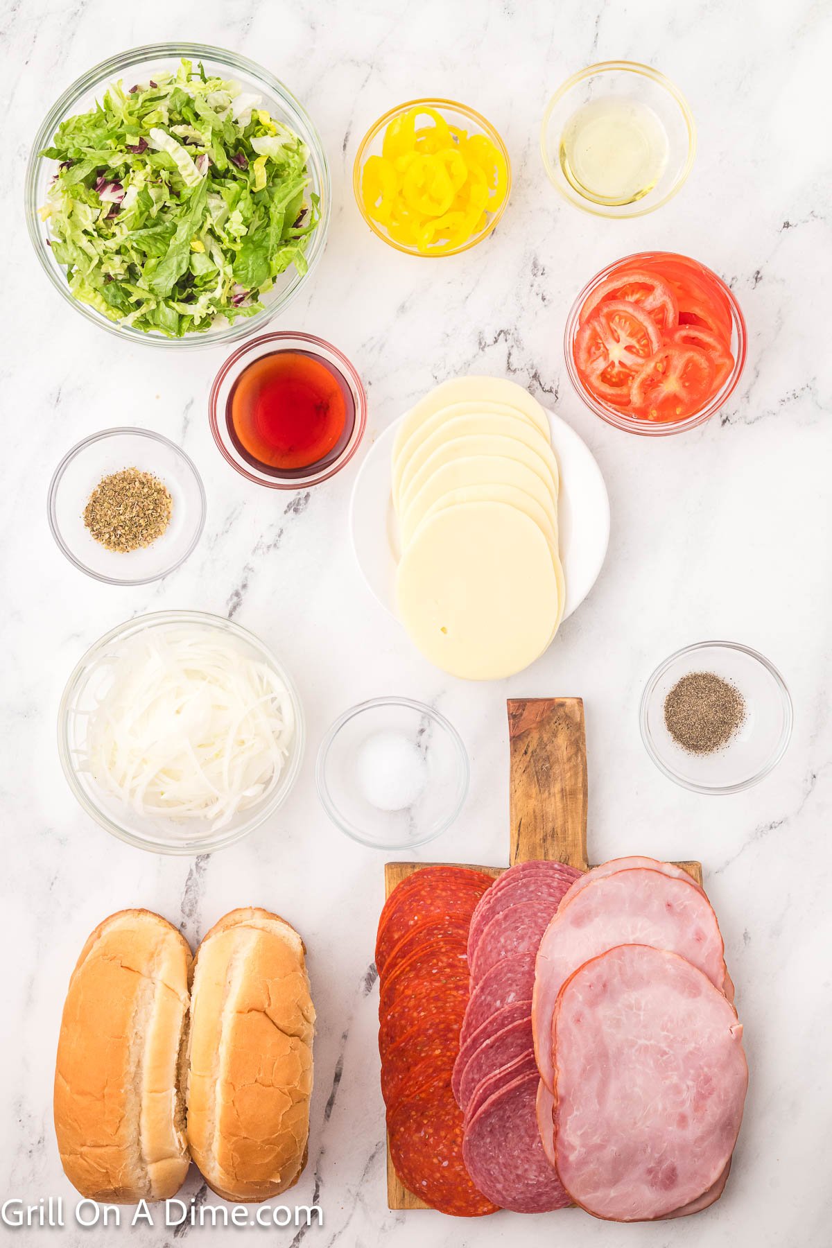 Ingredients - Hoagie Rolls, avocado oil, yellow pepper rings, onion, sliced ham, salami and pepperoni, provolone cheese, red wine vinegar, oregano, salt, pepper, tomatoes, lettuce