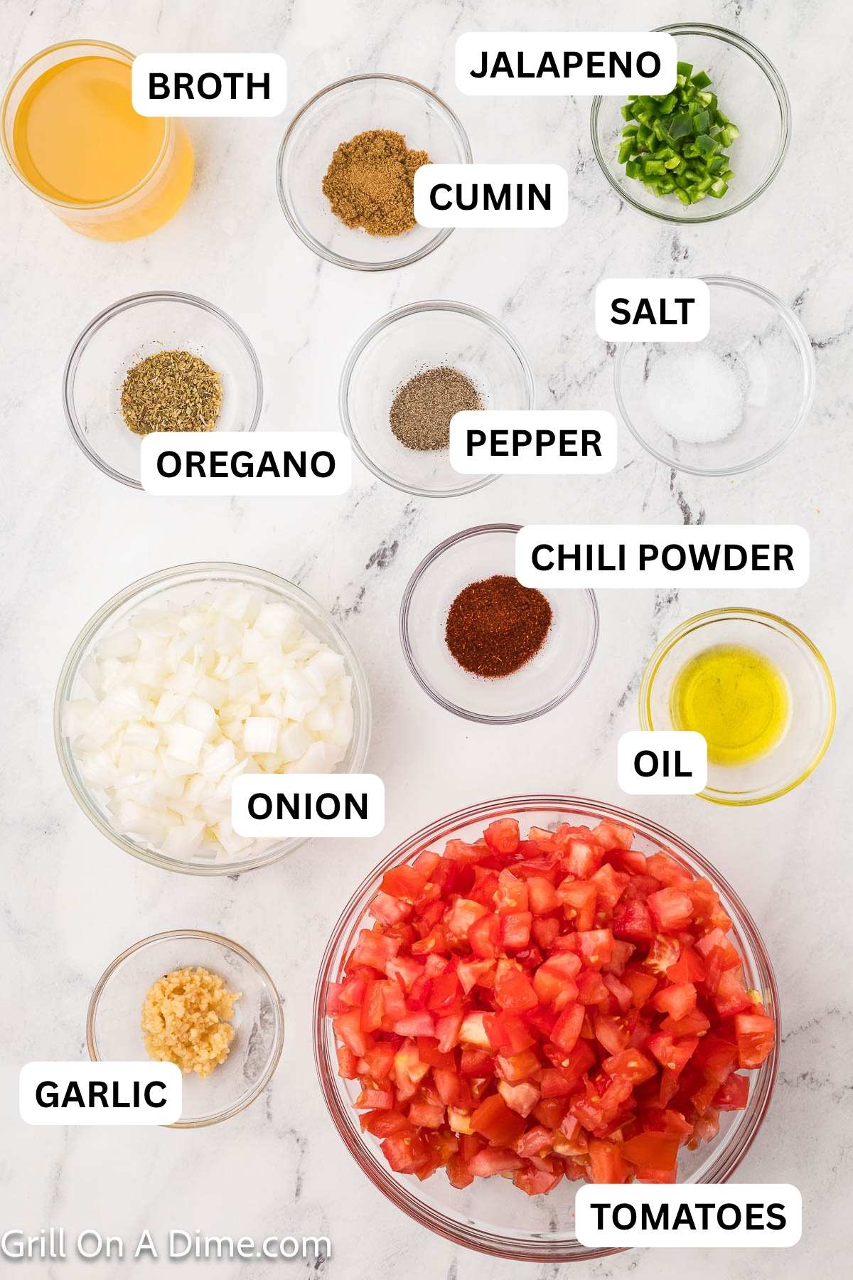 Ingredients needed to make this recipe which includes Large tomatoes, jalapeno, white onion, minced garlic, olive oil, chicken broth, chili powder, cumin, salt, oregano, and pepper.