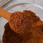Chipotle Seasoning filled in a teaspoon over a bowl of the spice blend.