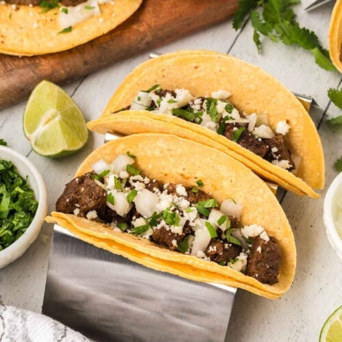 Mexican beef tacos on a cutting board.