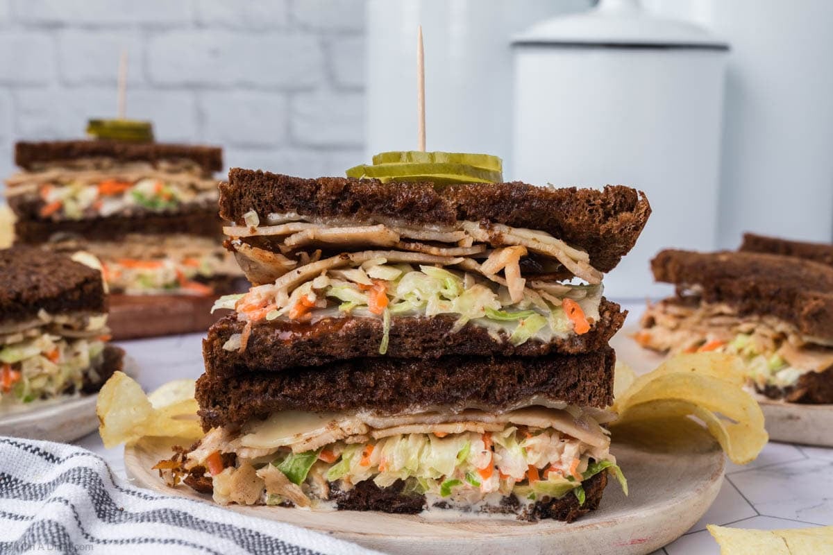 Rachel Sandwich cut in half and stacked on a plate.