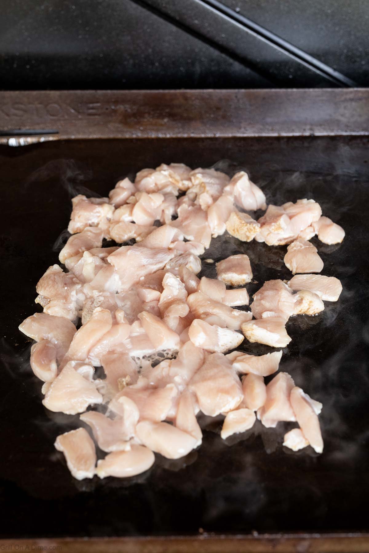 Diced chicken placed on the griddle