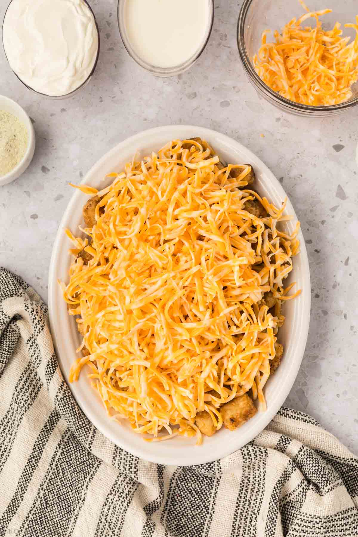 Shredded Cheese on a plate of crispy tater tots