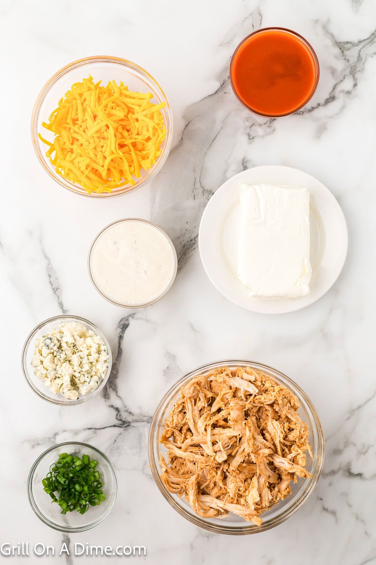 Ingredients - shredded chicken, green onions, blue cheese crumbles, ranch dressing, cream cheese, shredded cheese and buffalo sauce