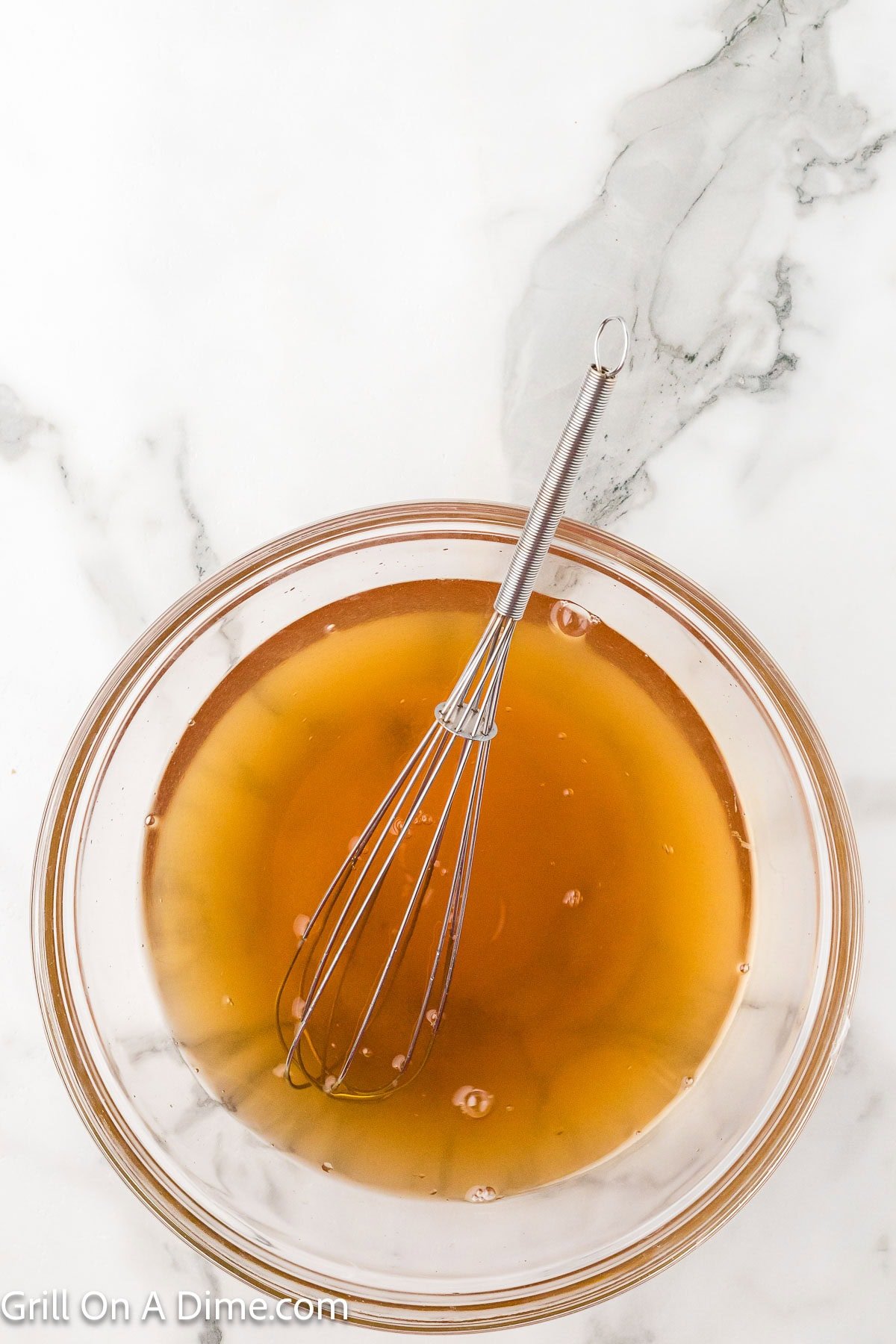 Brine ingredients in a bowl with a whisk