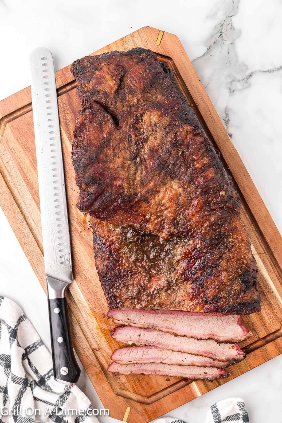 Slicing the cooled brisket on the cutting board