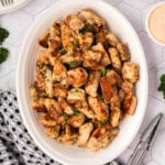 Chicken bites in a white serving dish.
