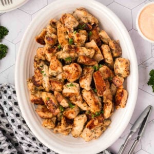 Chicken bites in a white serving dish.