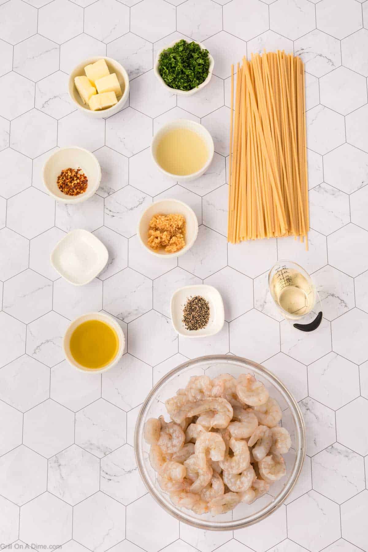 Ingredients - Pasta, shrimp, olive oil, butter, garlic cloves, spices, white wine, lemon chopped parsley