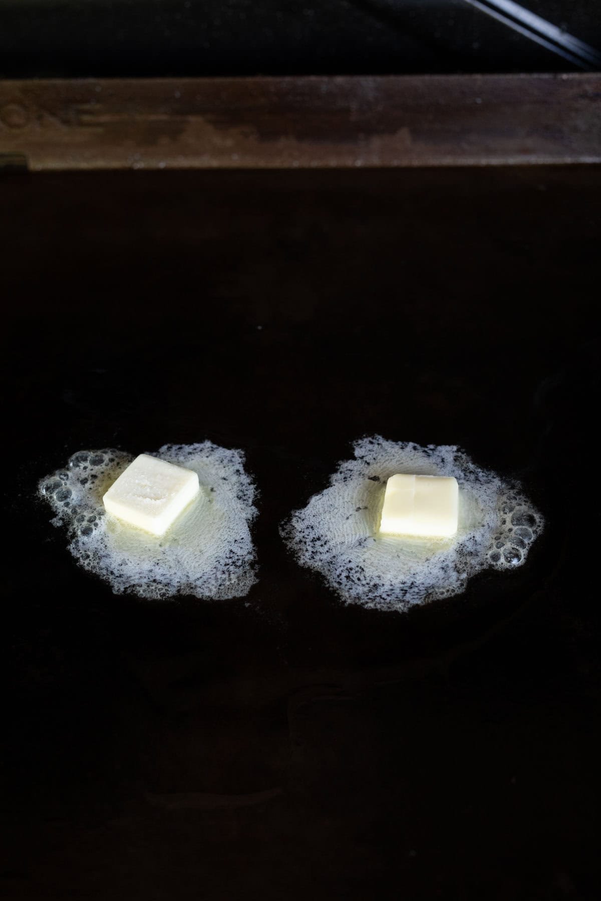 Melted butter on the flat top grill