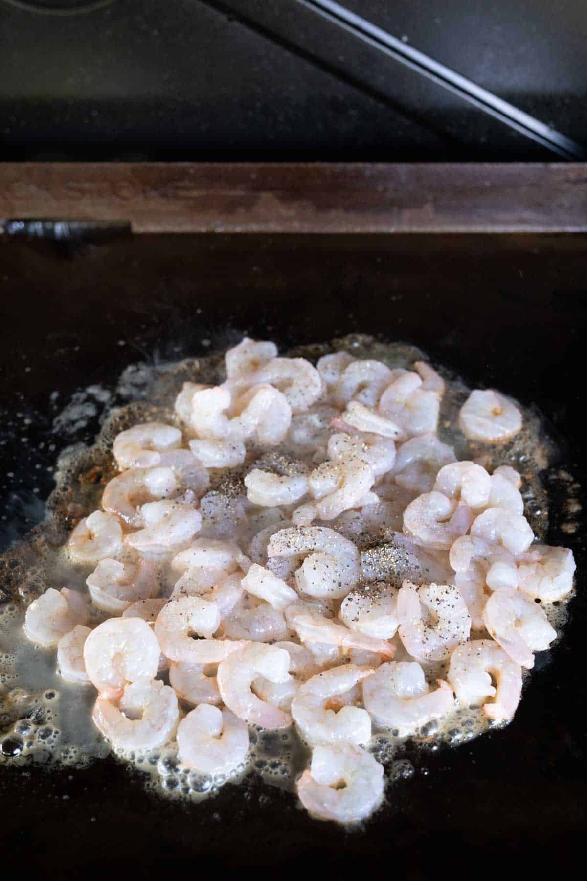 Cooking shrimp with seasoning on the top with melted butter