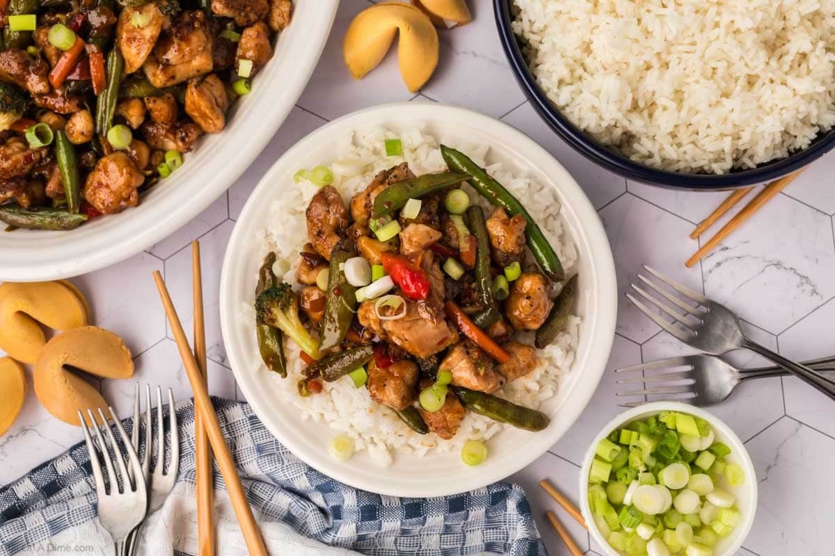 Chicken Stir Fry on a plate with white rice and a side of white rice and chicken stir fry