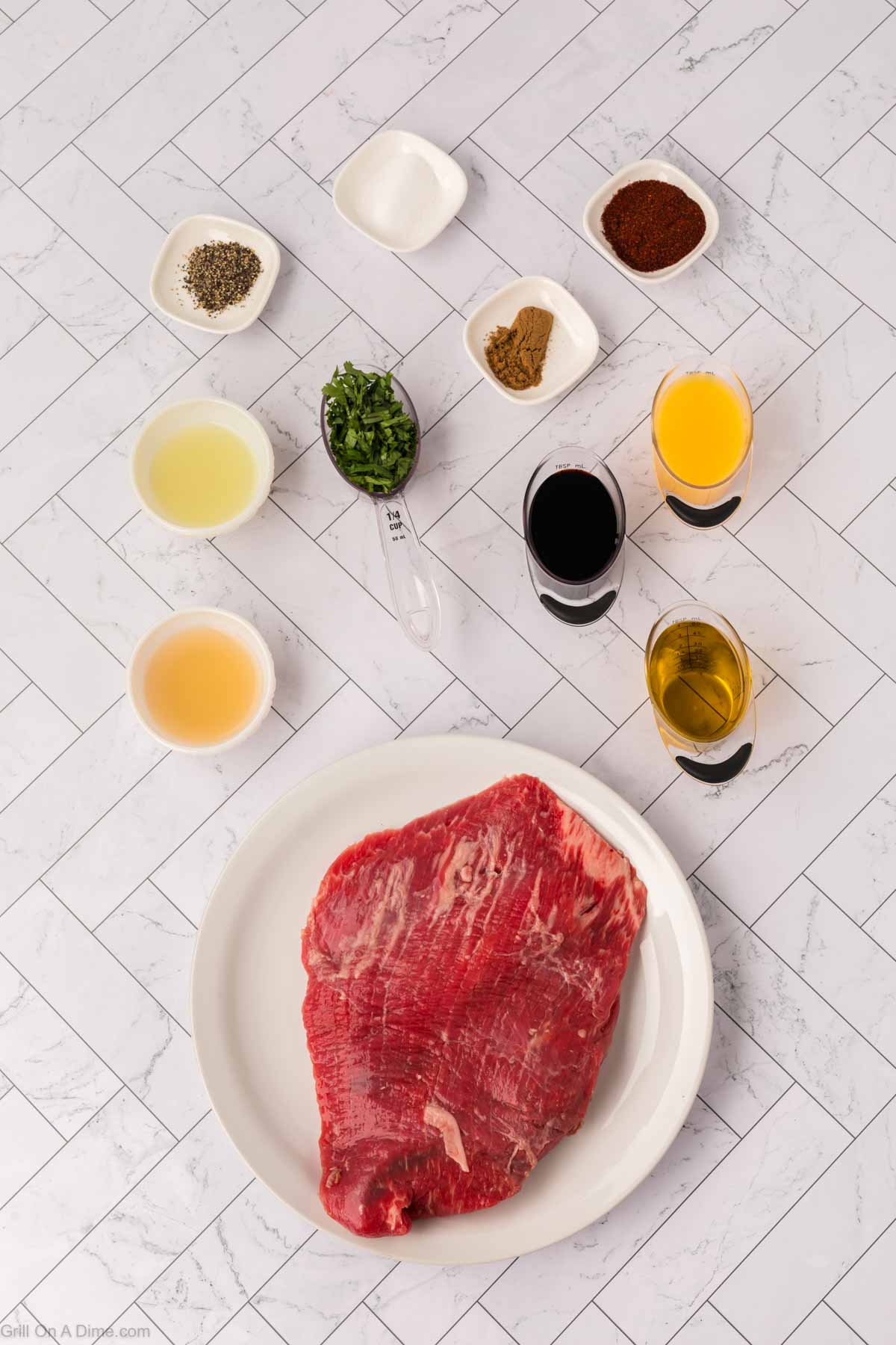 Ingredients - Flank Steak, olive oil, soy sauce, orange juice, lime, apple cider vinegar, chili powder, cumin, salt and pepper