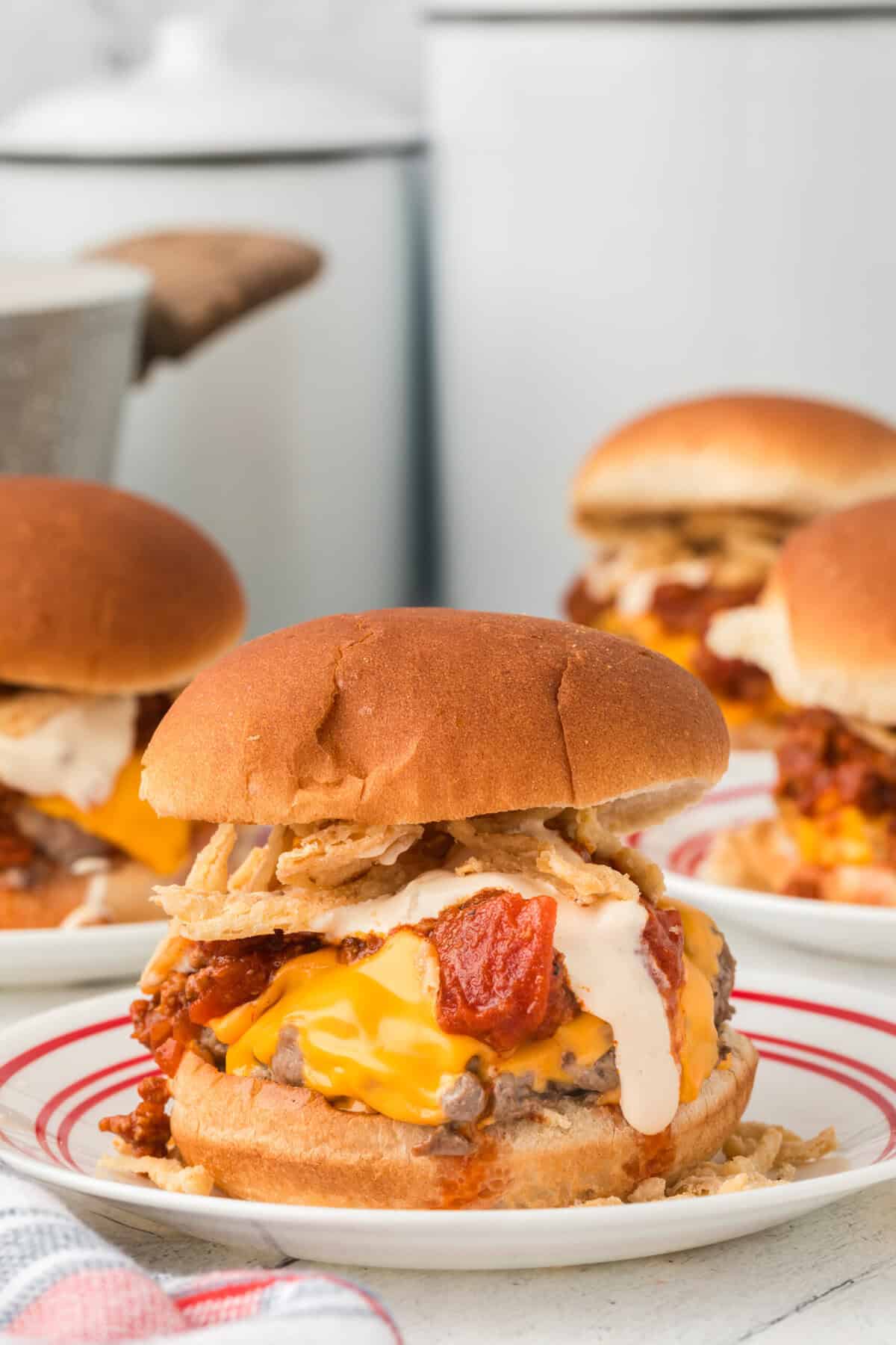 chili cheese burger recipe loaded with bacon and cheese on plate
