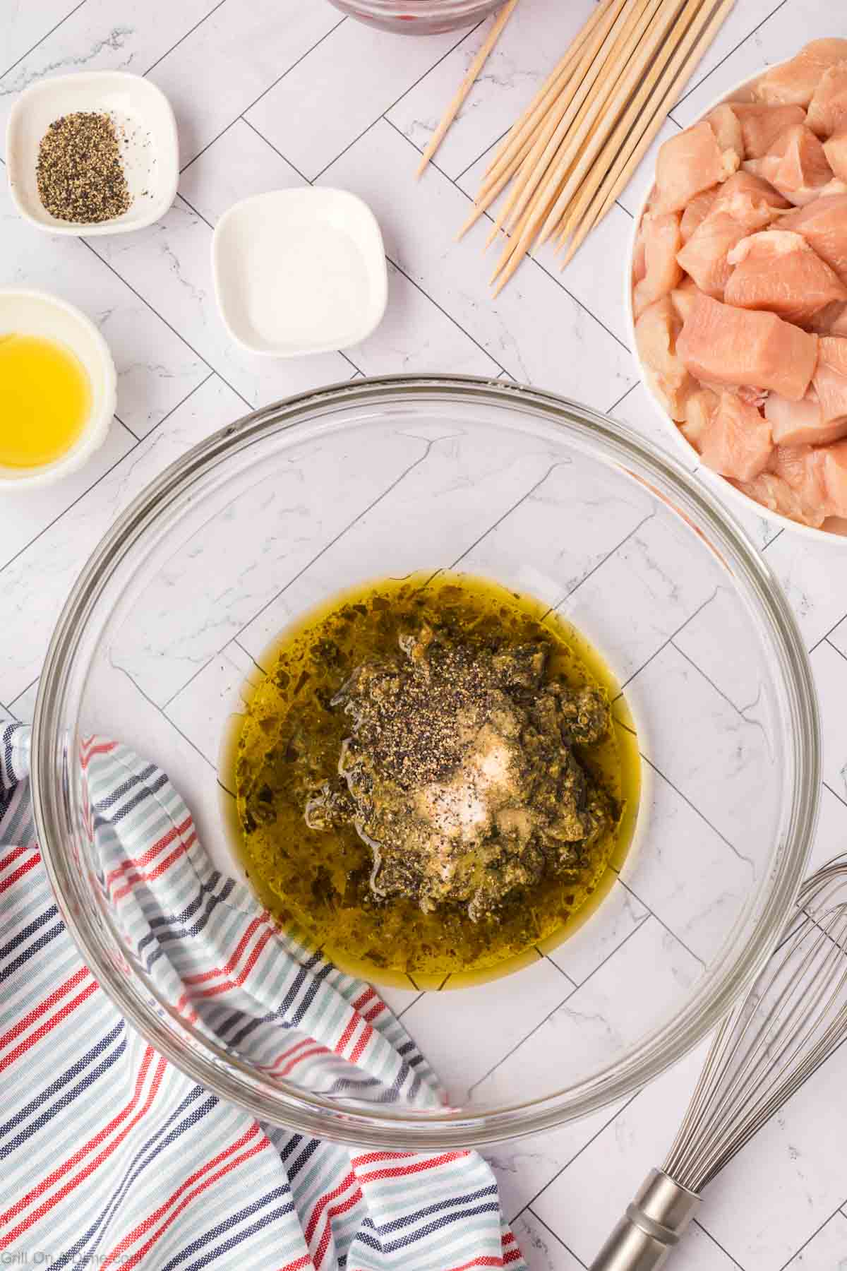 Combining pesto sauce ingredient together in a bowl 