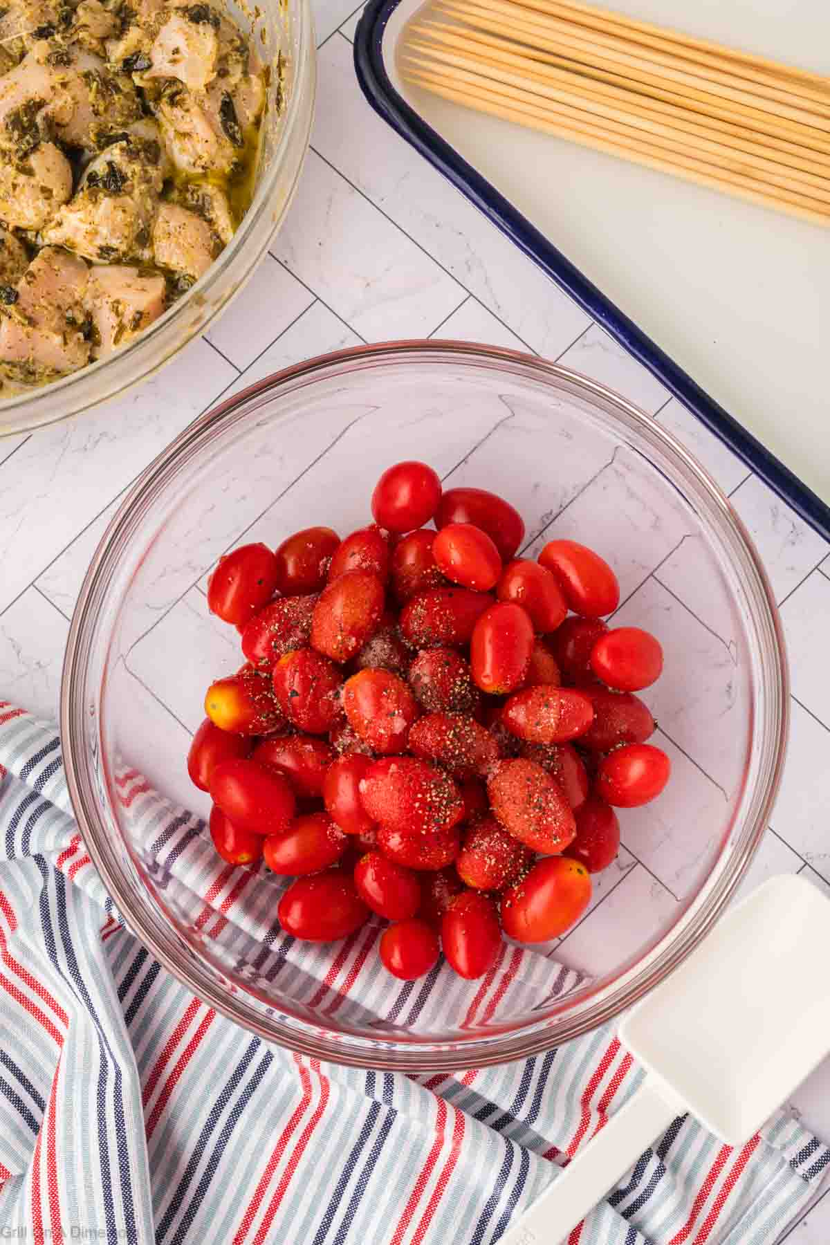 Cherry tomatoes topped with olive oil, salt, and pepper