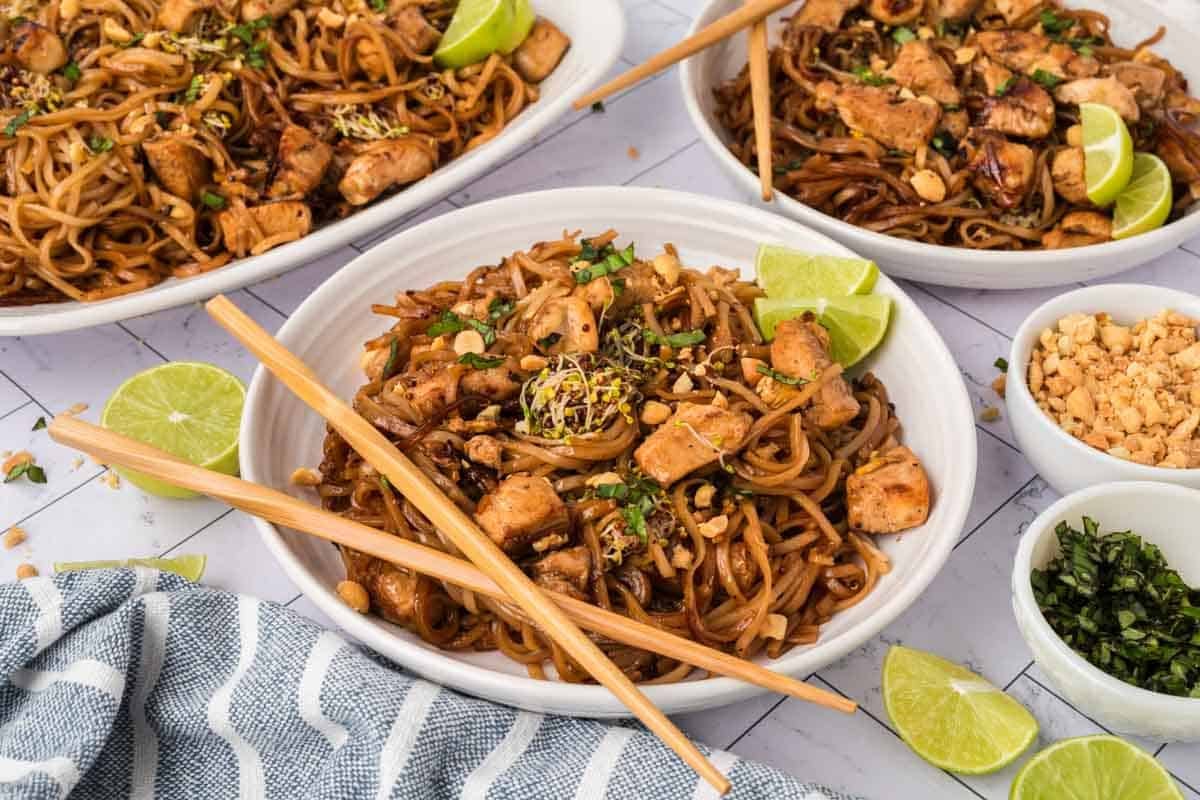 A serving of the pad thai on a plate with chopsticks