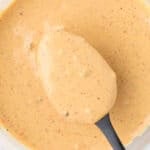 Creamy sauce with black pepper flecks, perfect for dipping or drizzling.