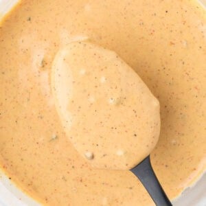 Creamy sauce with black pepper flecks, perfect for dipping or drizzling.