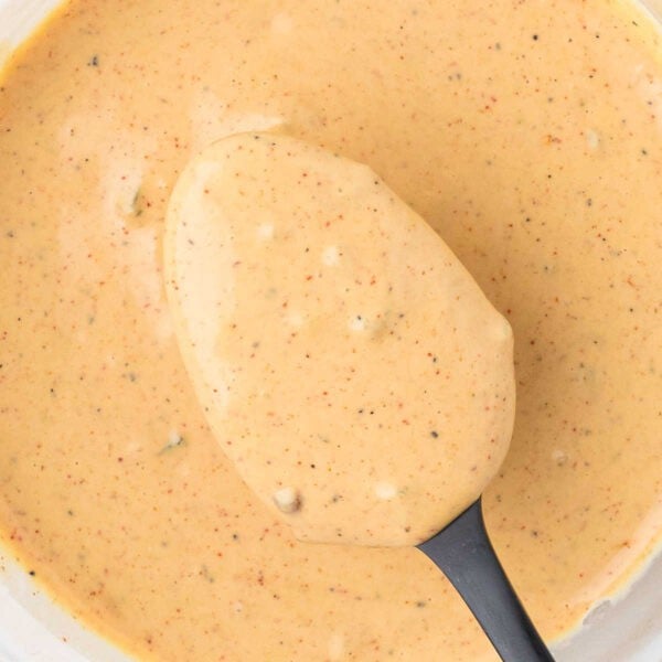 Creamy sauce with black pepper flecks, perfect for dipping or drizzling.