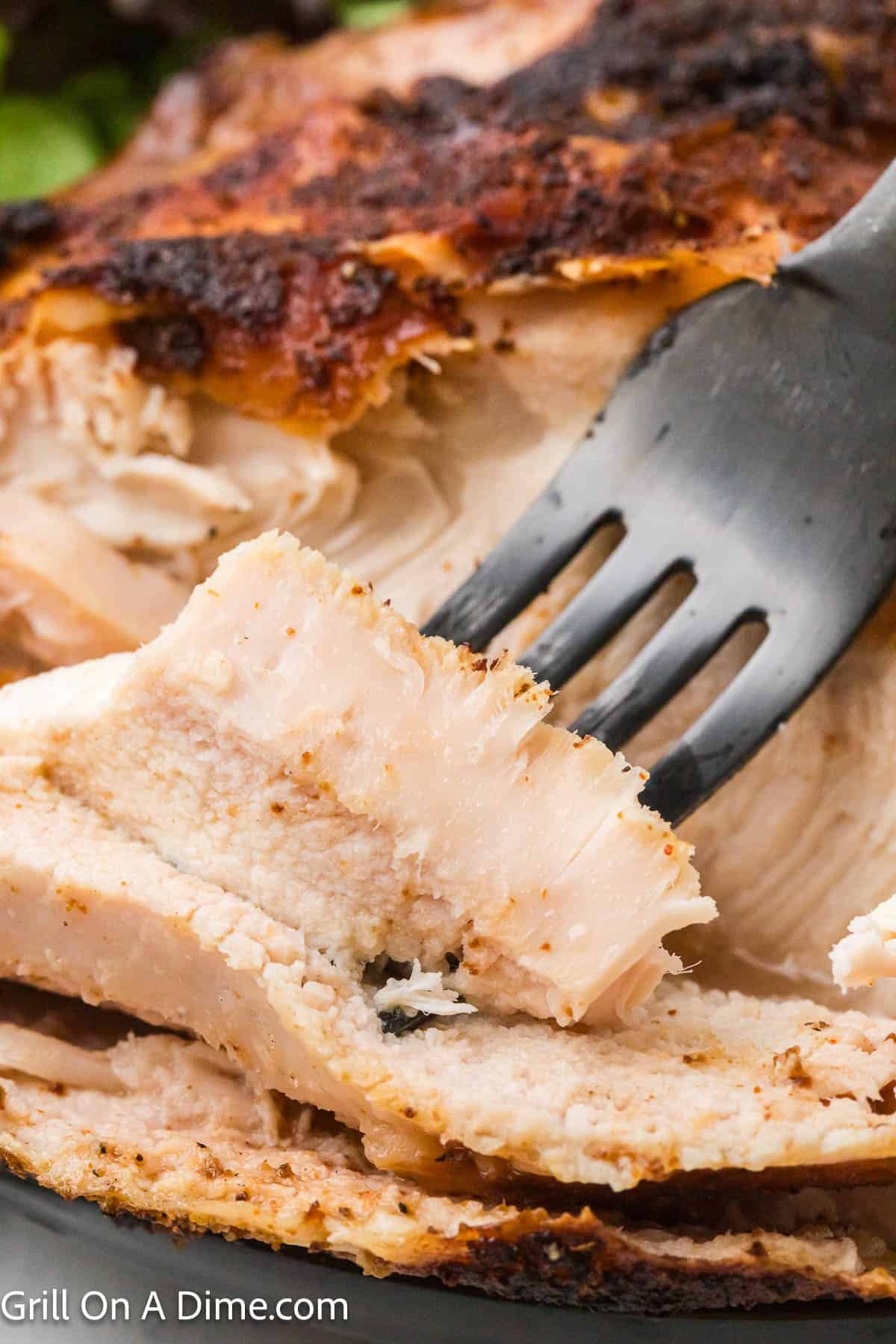 Smoked chicken breast sliced with a fork