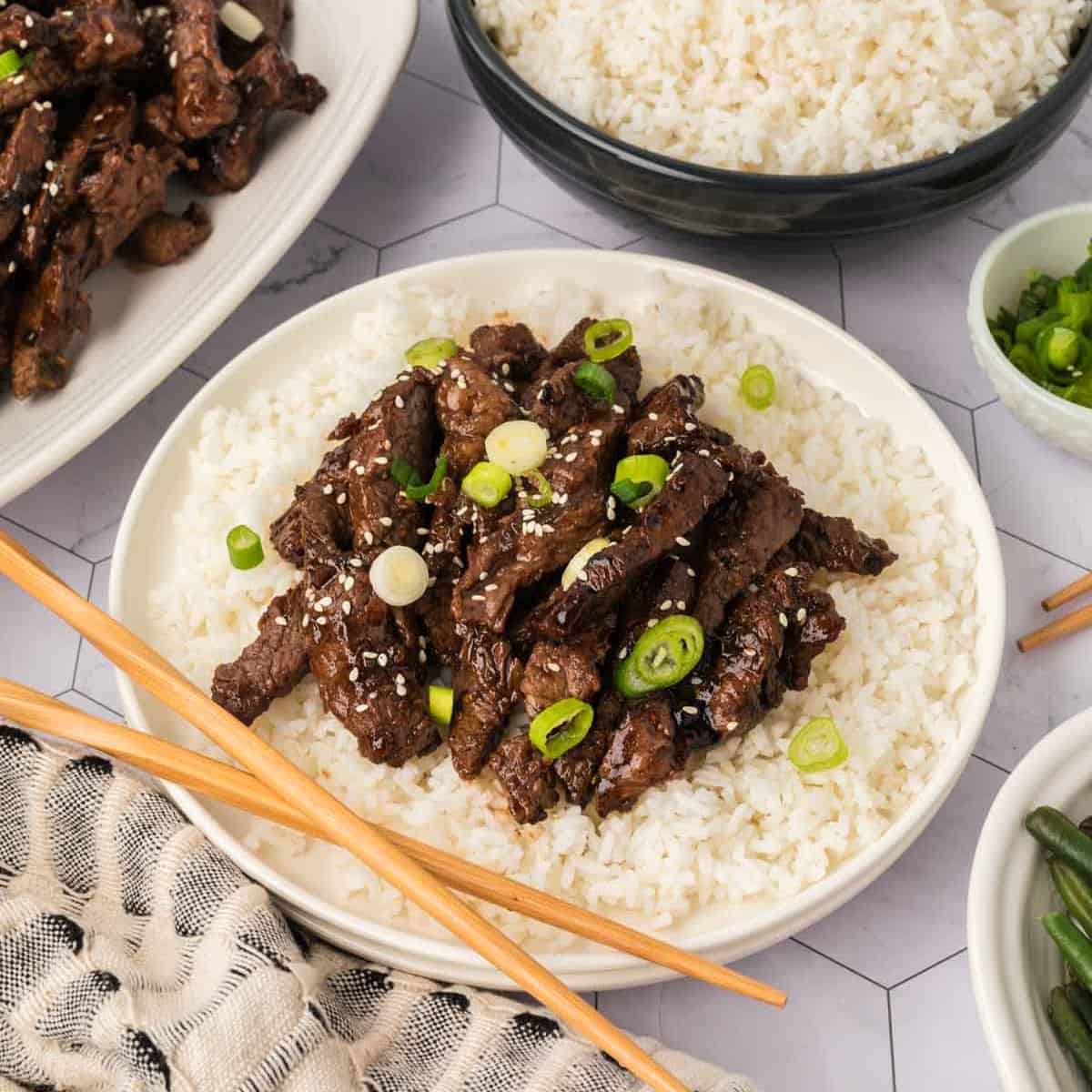 Korean BBQ Beef on a plate with white rice and chopsticks
