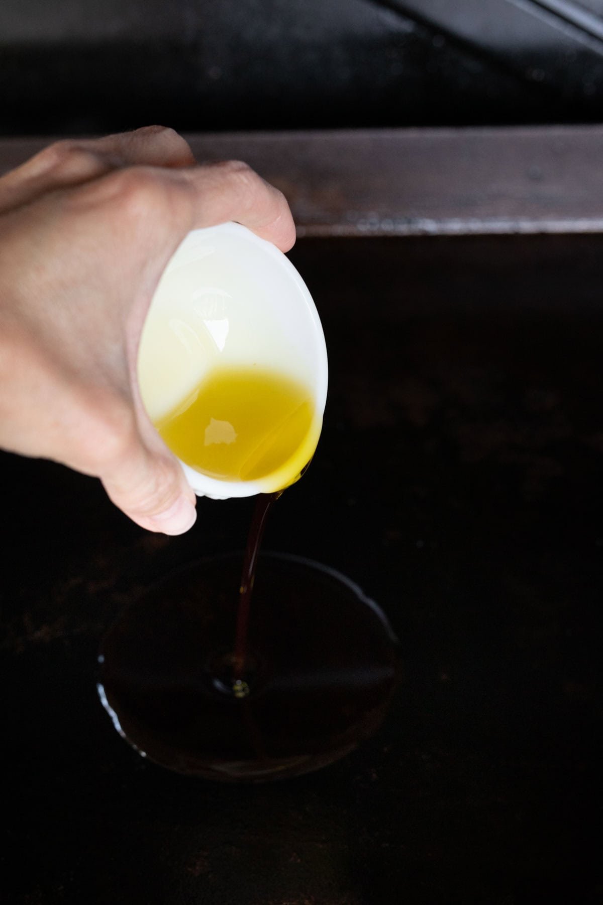 Pouring the oil onto the griddle