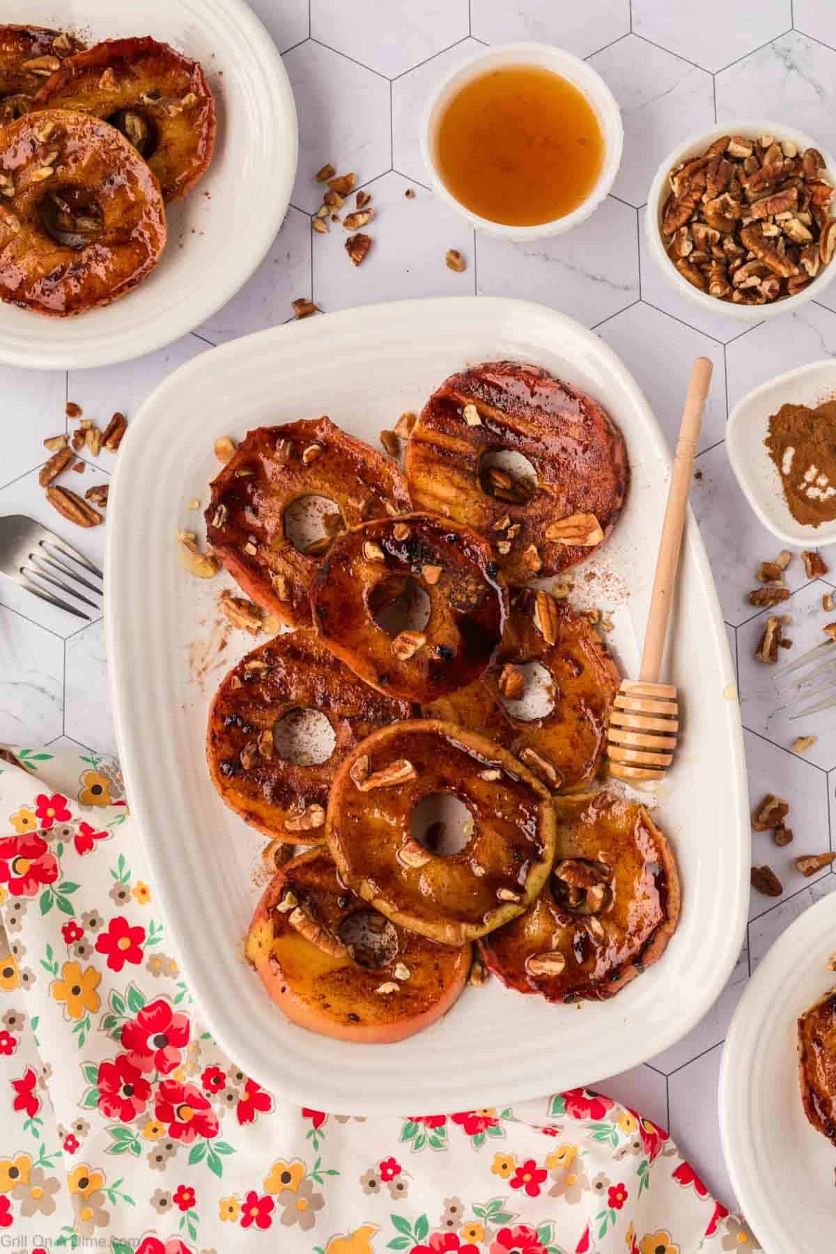 Apple Slices on a platter topped with the cinnamon mixture and chopped pecans