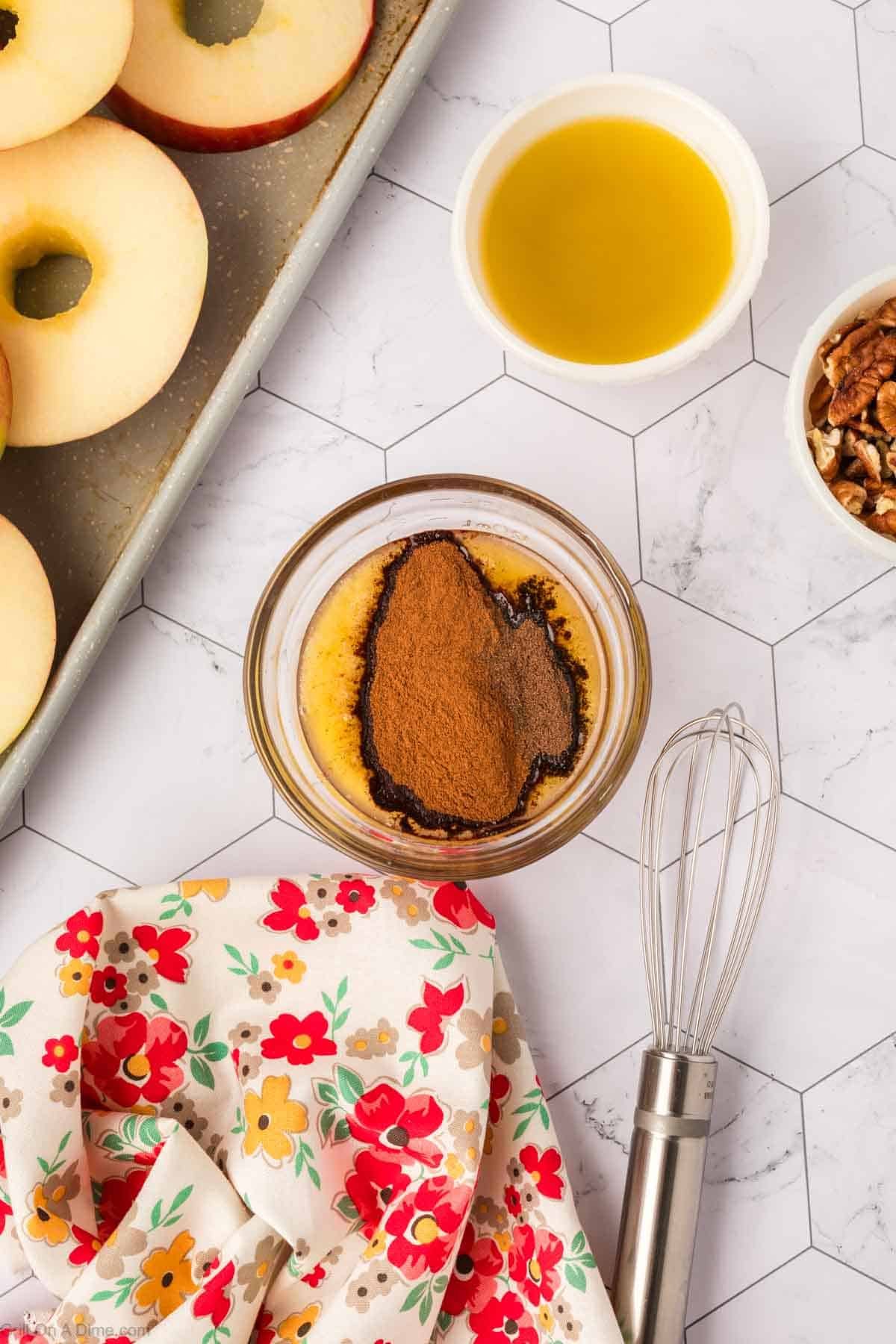 Combining the melted butter with the spices in a bowl