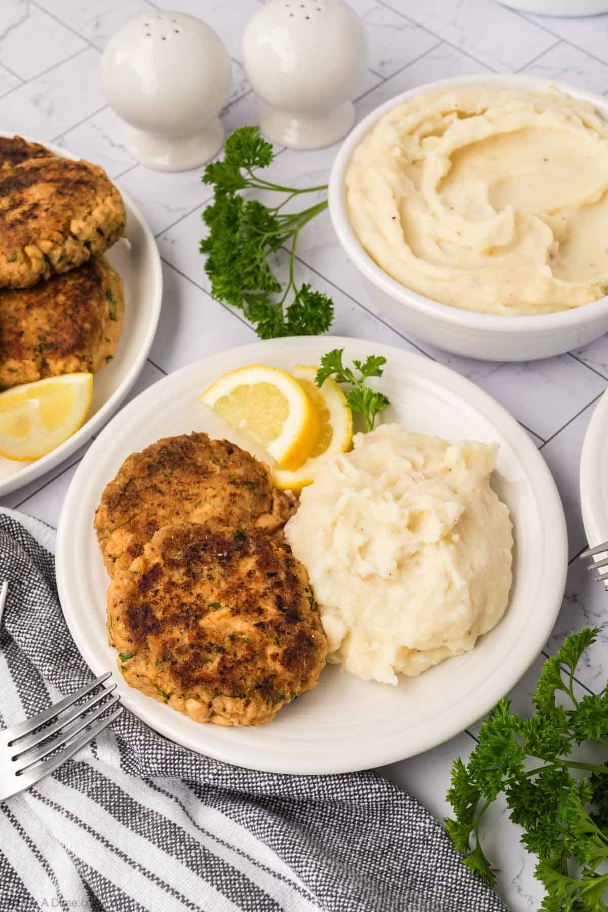 Salmon Patties on a plate with mashed potatoes on the side