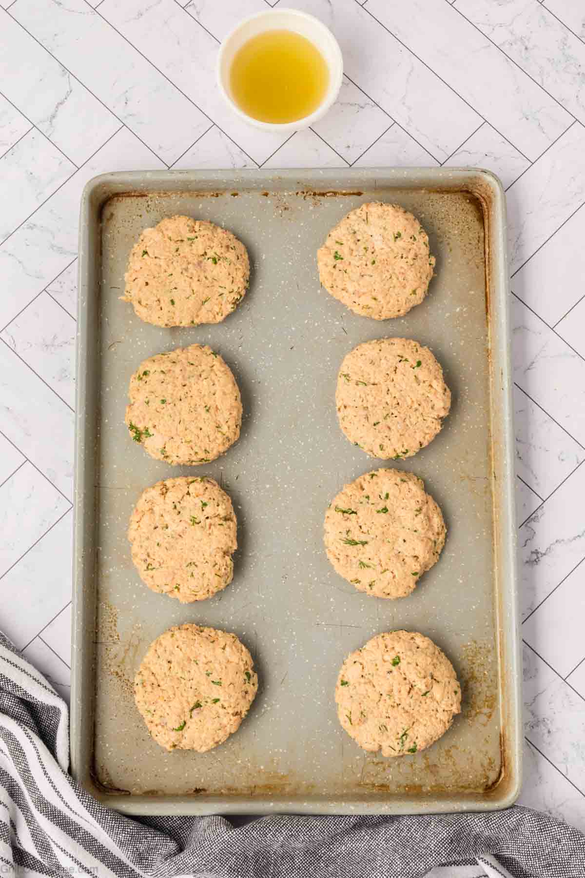 Salmon patties on a baking sheet
