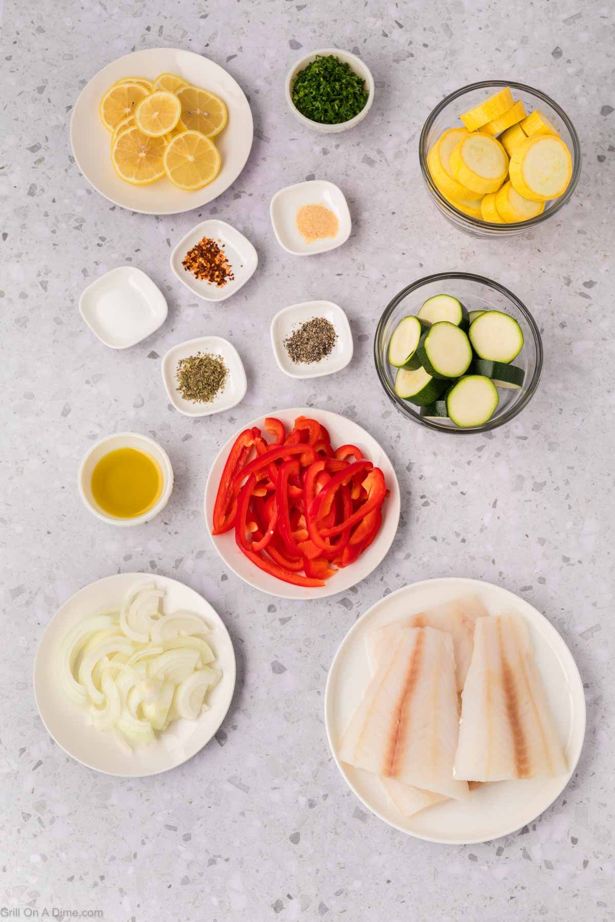 Ingredients - White Fish Fillets, slice squash, zucchini, red bell pepper, and onion, lemon, salt, pepper, Italian Seasoning, garlic powder, red pepper flakes, fresh parsley