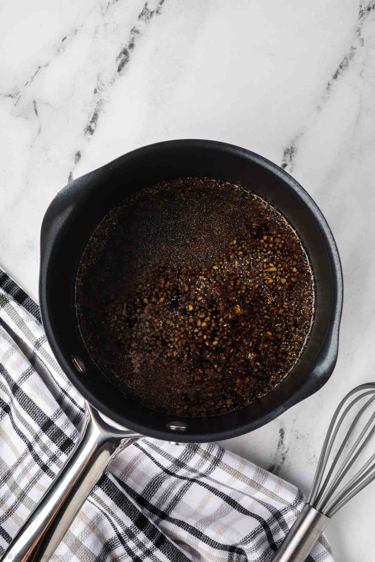 Ingredients to make sauce is mixed together in a large saucepan.