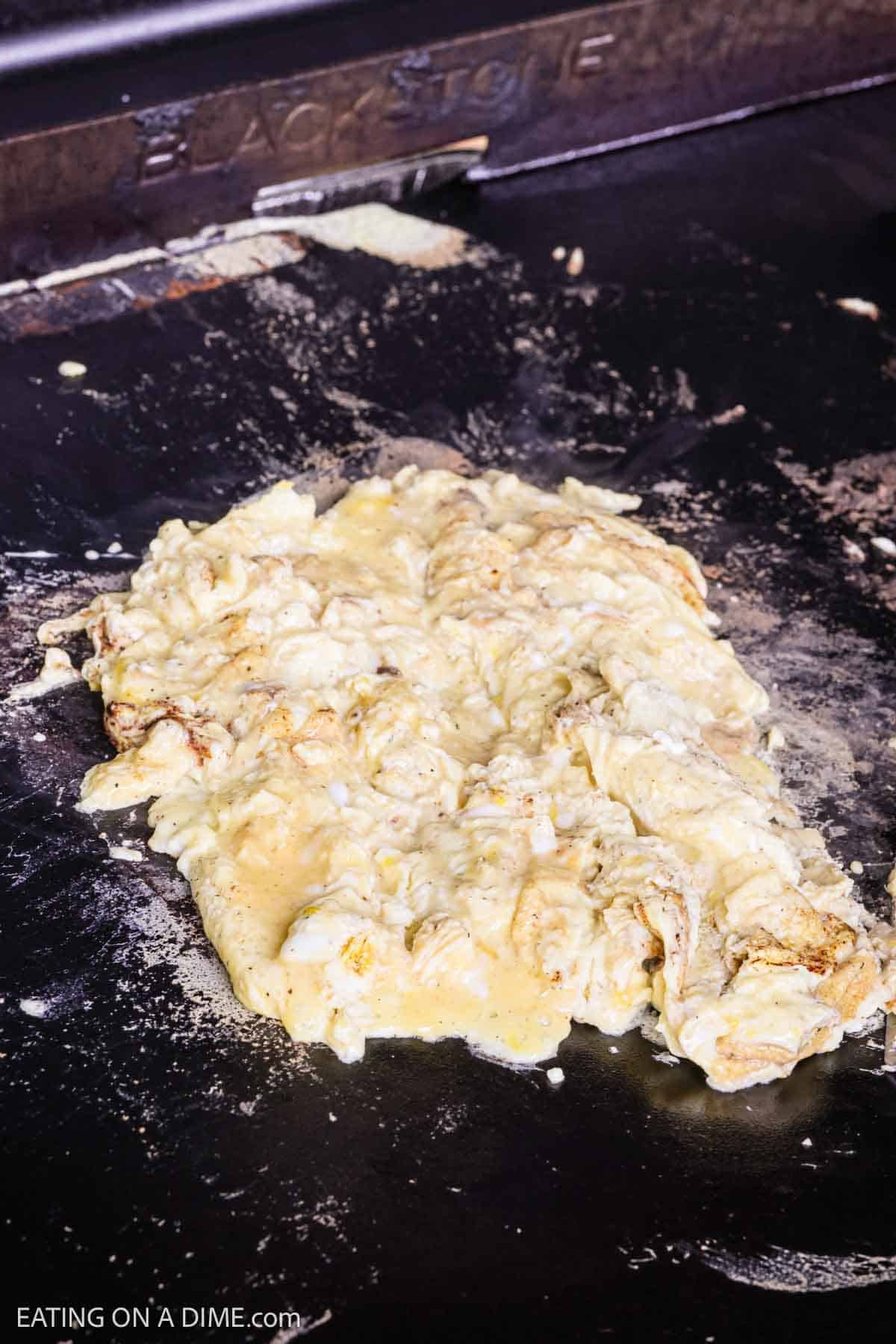Cooking scrambled eggs on a Blackstone eggs. 