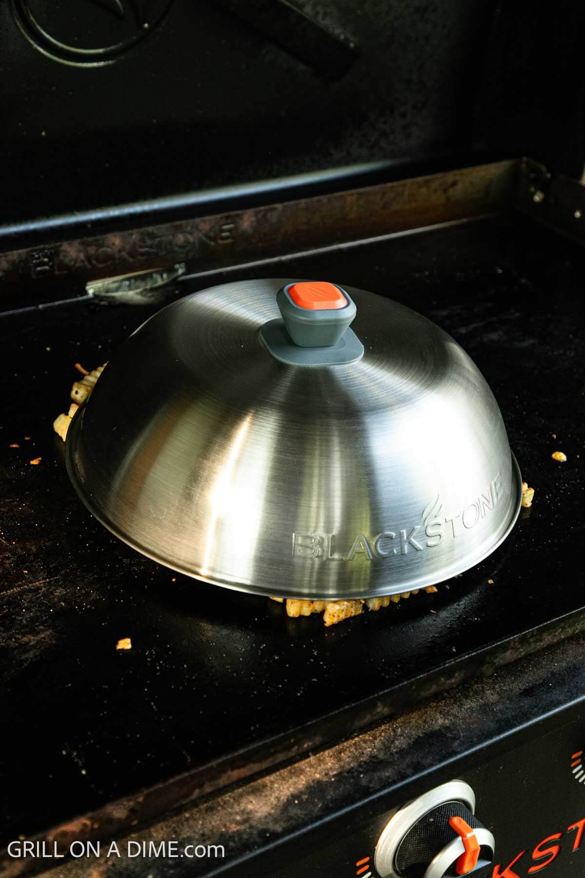 Dome over the loaded french fries on the Blackstone Griddle. 