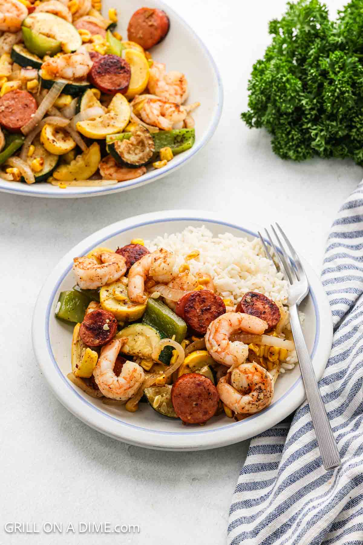 A serving of the stir fry on a plate with white rice.