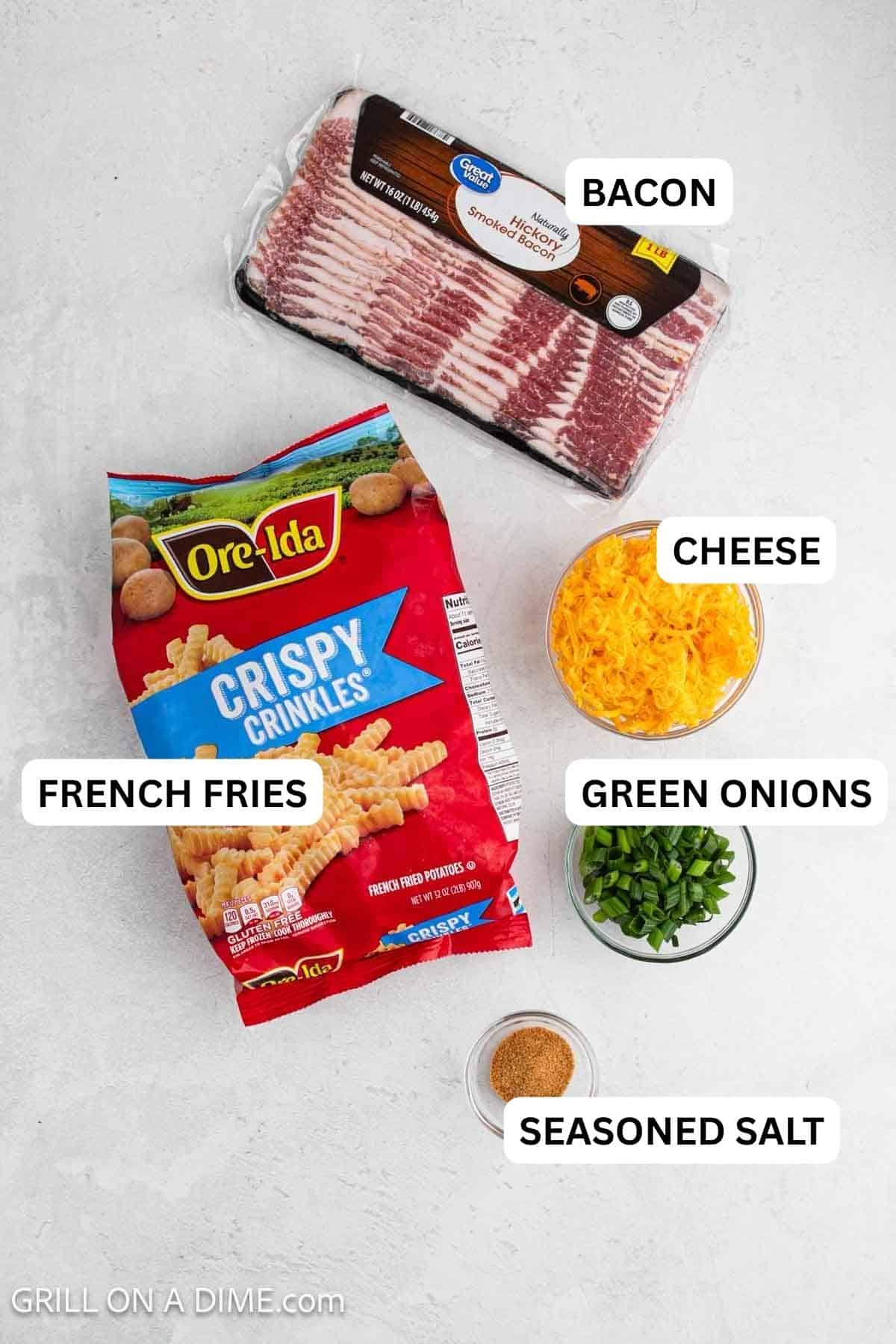 Ingredients needed for this recipe which includes frozen french fries, shredded cheese, chopped  green onions, seasoned salt and bacon. 