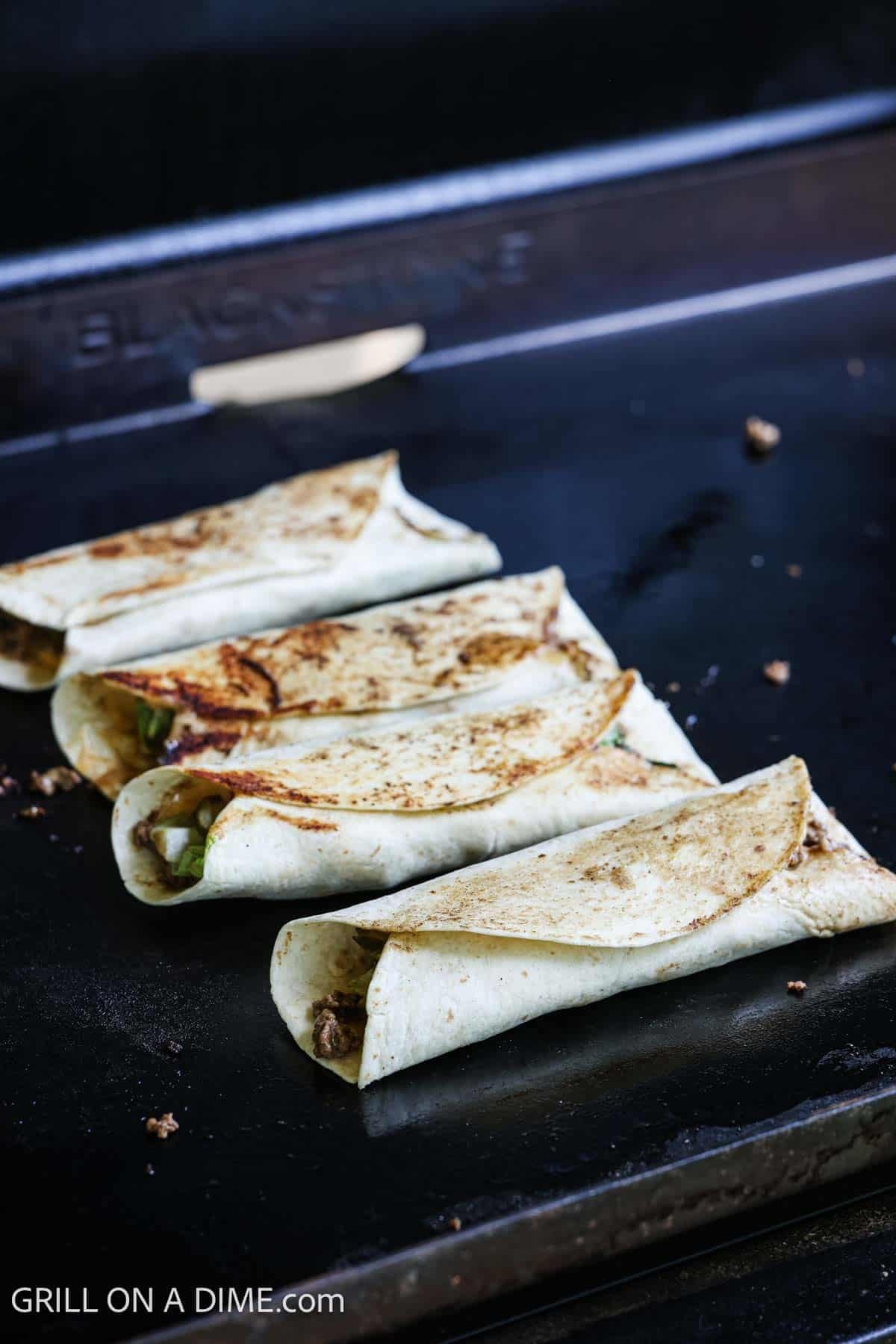 Cooking the wraps on the flat top griddle.