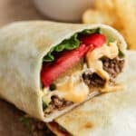 Cheeseburger wrap cut in half and stacked.