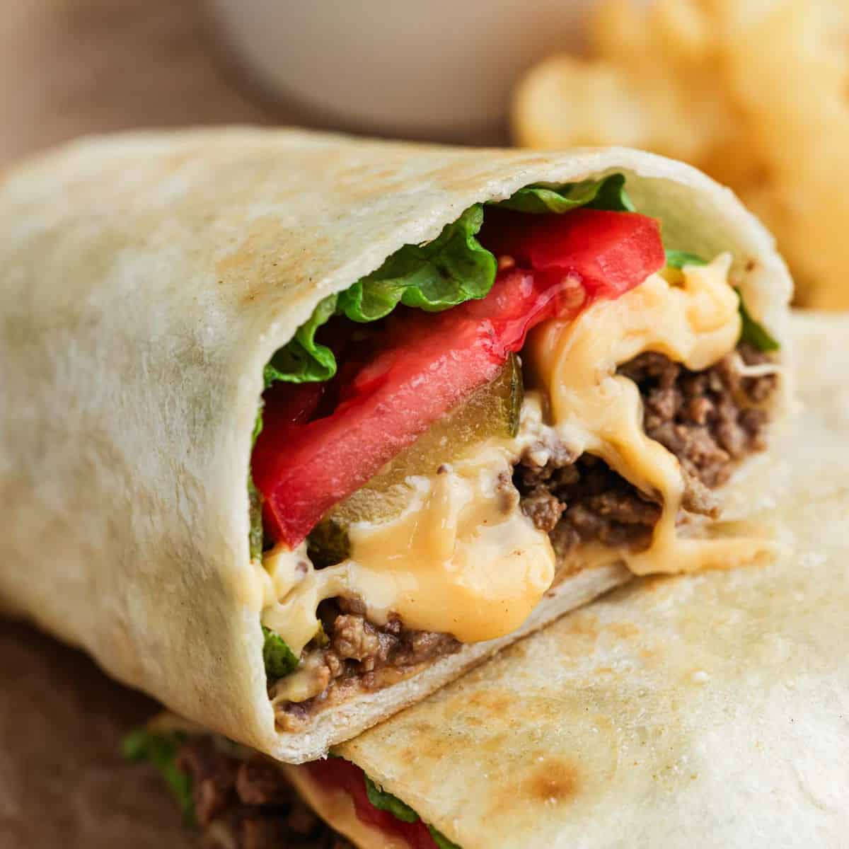 Cheeseburger wrap cut in half and stacked.