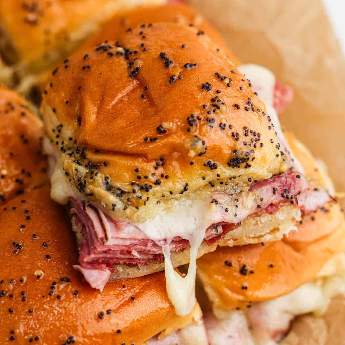 Ham and cheese sliders stacked on top of each other.